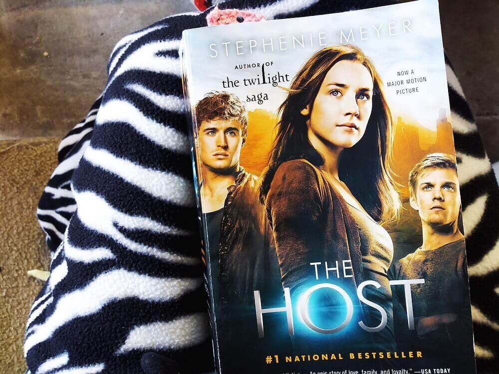 "The Host" by Stephenie Meyer atop a zebra blanket on my lap