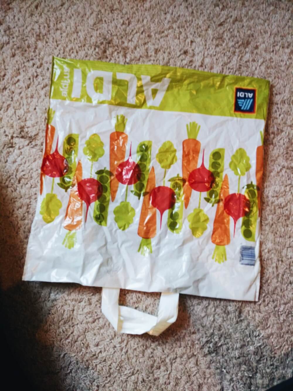 Flattened Aldi grocery bag upside down on floor
