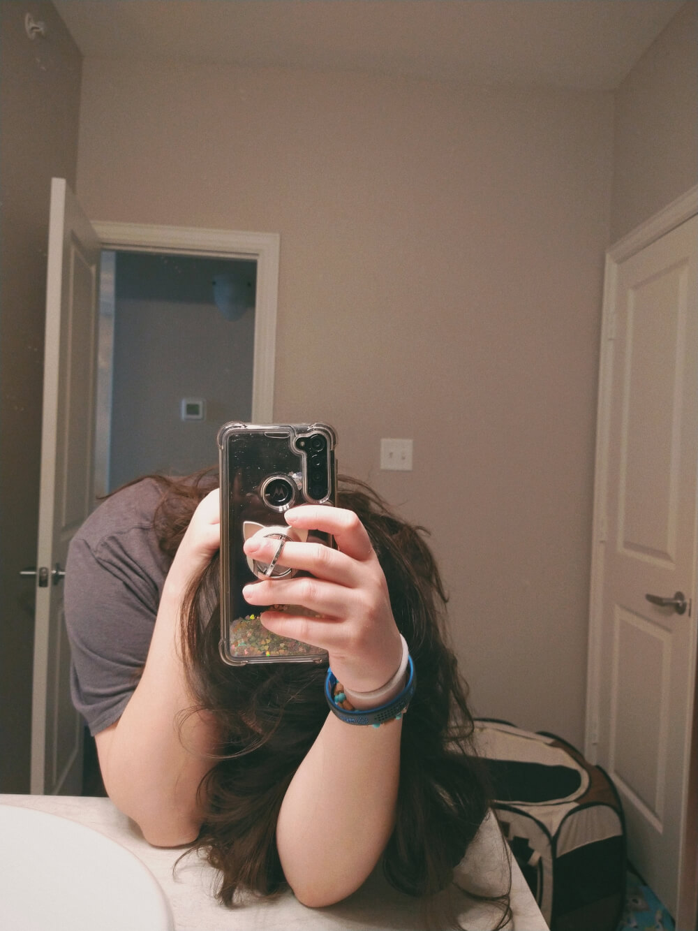 Bathroom mirror selfie, head down, phone up