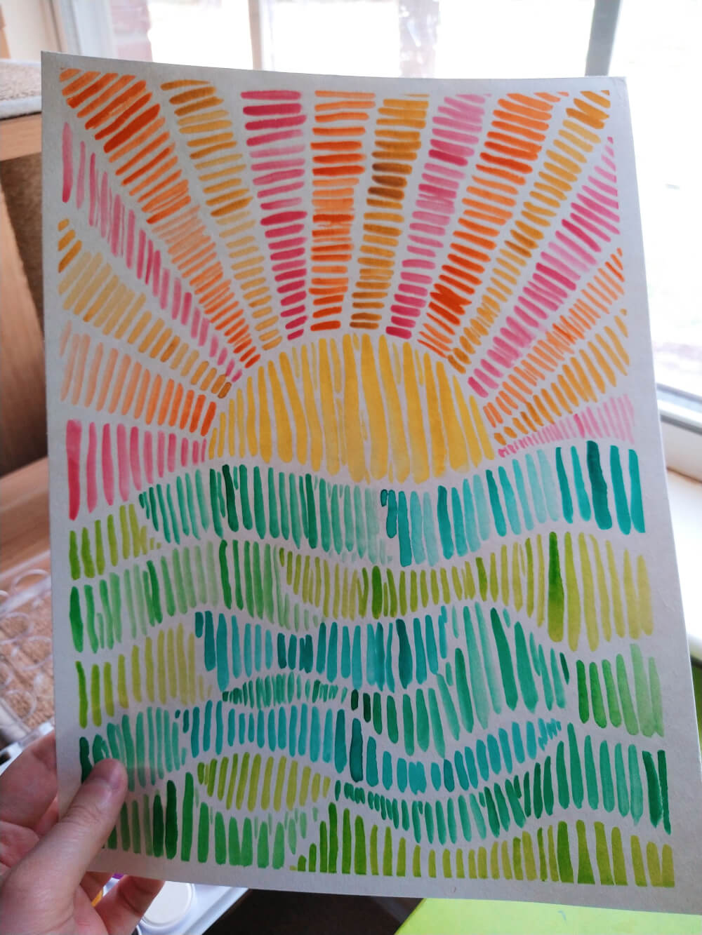 Watercolor painting ft. small vertical lines: wavy sections of differing hues of green lines on the bottom half; yellow lines in a semicircle sun with pink, orange and gold rays of lines