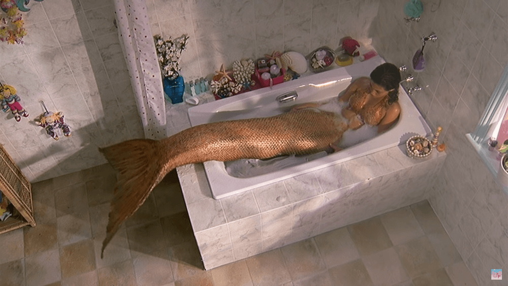 Cleo pouting in the tub about being a mermaid
