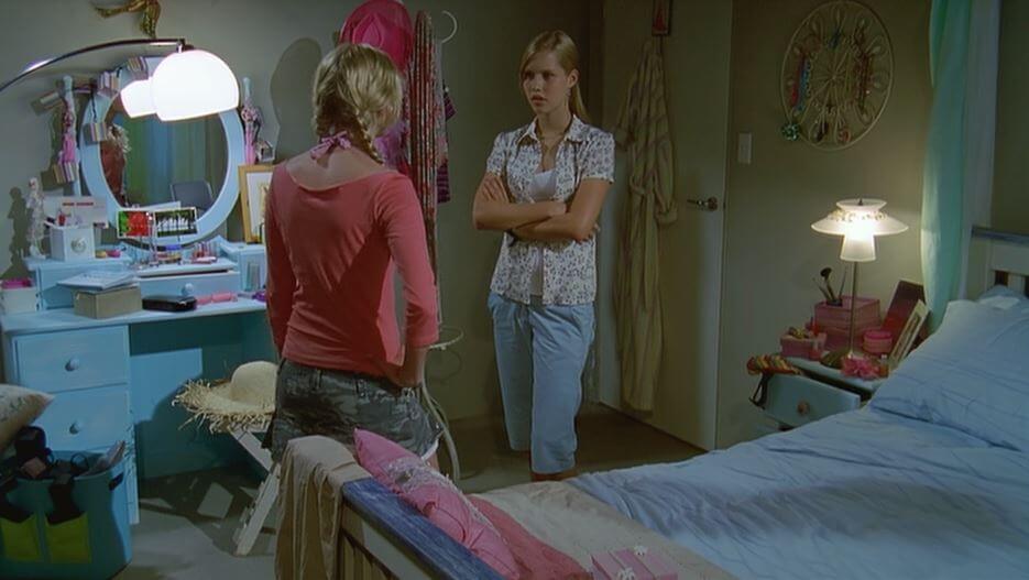 Rikki and Emma chatting in her bedroom, which is nautical-themed