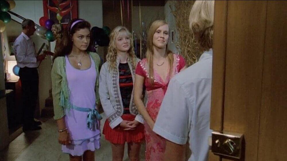 Lewis standing in the front doorway across from Emma, Rikki and Cleo